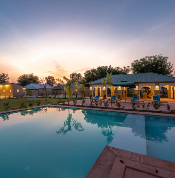 Aangan Resort pool at sunset